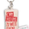 Schlüsselanhänger Mini Plüschkissen "Komm, lass uns zu weit gehen!" m. Glöckchen